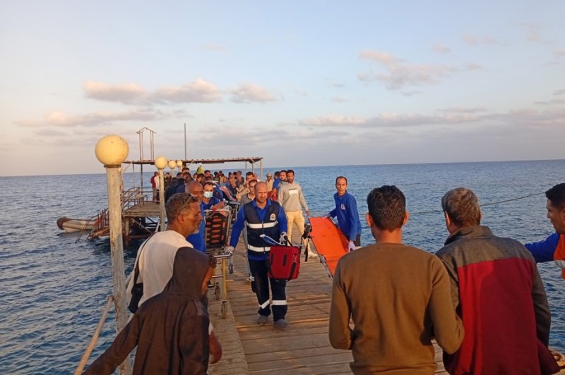 Medics and people wait for possible survivors after a boat sank near the harbor in Marsa Alam, Red Sea Governorate, in Egypt on Monday. Photo by EPA-EFE