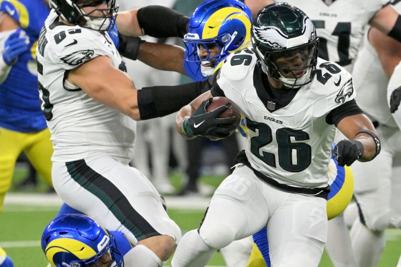 Philadelphia Eagles running back Saquon Barkley (26) runs past Los Angeles Rams defenders Sunday at SoFi Stadium in Inglewood, Calif. Photo by Jon SooHoo/UPI