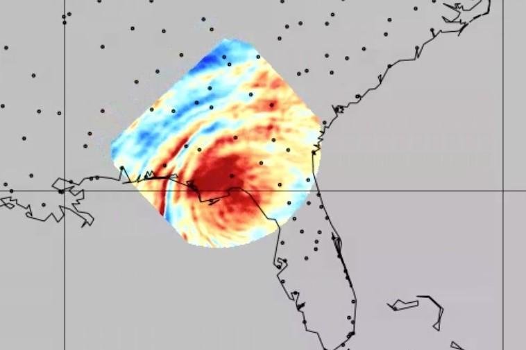 One of the first images produced by NASA's Atmospheric Waves Experiment shows concentric rings of gravity waves, artificially colored red, yellow and blue, produced by Hurricane Helene some 55 miles above Florida's Panhandle. The dots on the continent mark the locations of cities. Image courtesy NASA/Utah State University